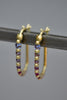 Ularis hoop earrings in purple and oink on gray by Polly Wales.