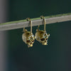 Side view of Green Enchanted Skull Safety Pin Earrings by Polly Wales.