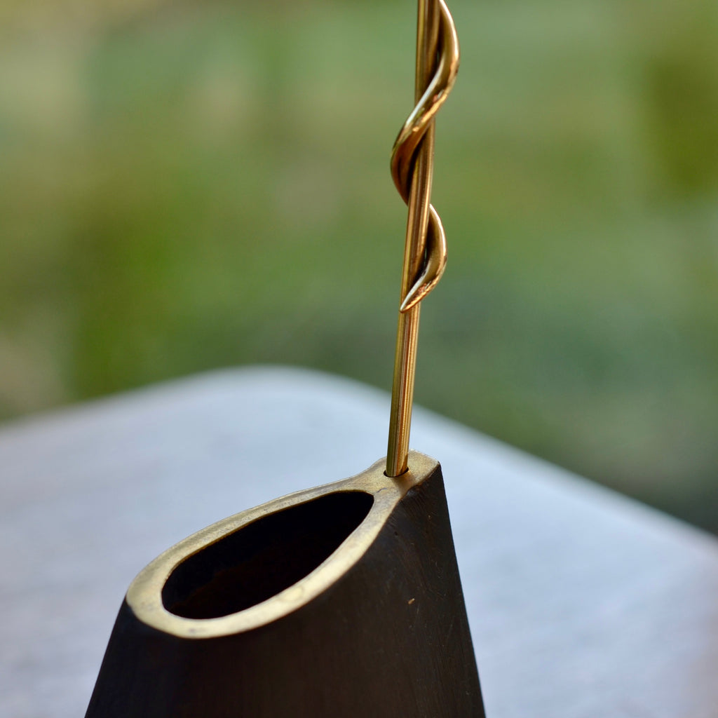 Detail on Aubock Vase 7240 Single Noose is a brass vase with patinated body, polished rim and rod. Designed by Carl Auböck