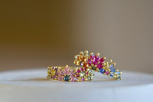 Rainbow Daisy Garland Ring and Rainbow Daisy Garland Petal Ring by Polly Wales.