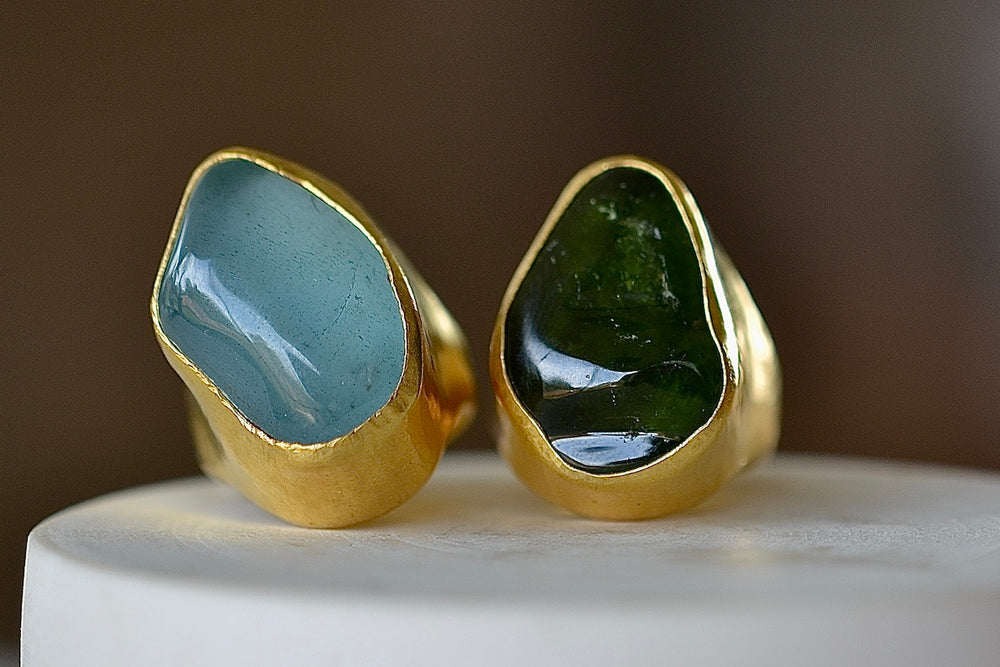 Tibetan rings in Aquamarine and Green Tourmaline, encased in 22k yellow gold. Designed by Pippa Small Jewellery. Unisex.