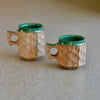 Lifestyle shot of large and medium Urushi green jincups in large and medium.