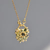 Green Fantaisie Encrusted Padlock Necklace by Polly Wales is a padlock in 18K yellow gold and encrusted with mixed green sapphires, a center cabochon and an accent diamond hanging on a chain that attaches to the lock handle by pulling the lever. Recycled gold. Cast in Place. Cast not set. 