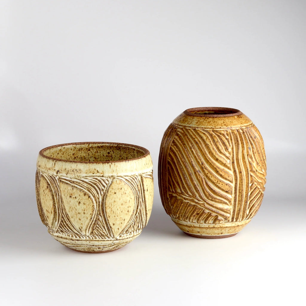 Two one of a kind hand carved Irving Place Studio (IPS) Ceramic Vases in cream and brown made by Dora De Larios (1933-2018) on white background. 