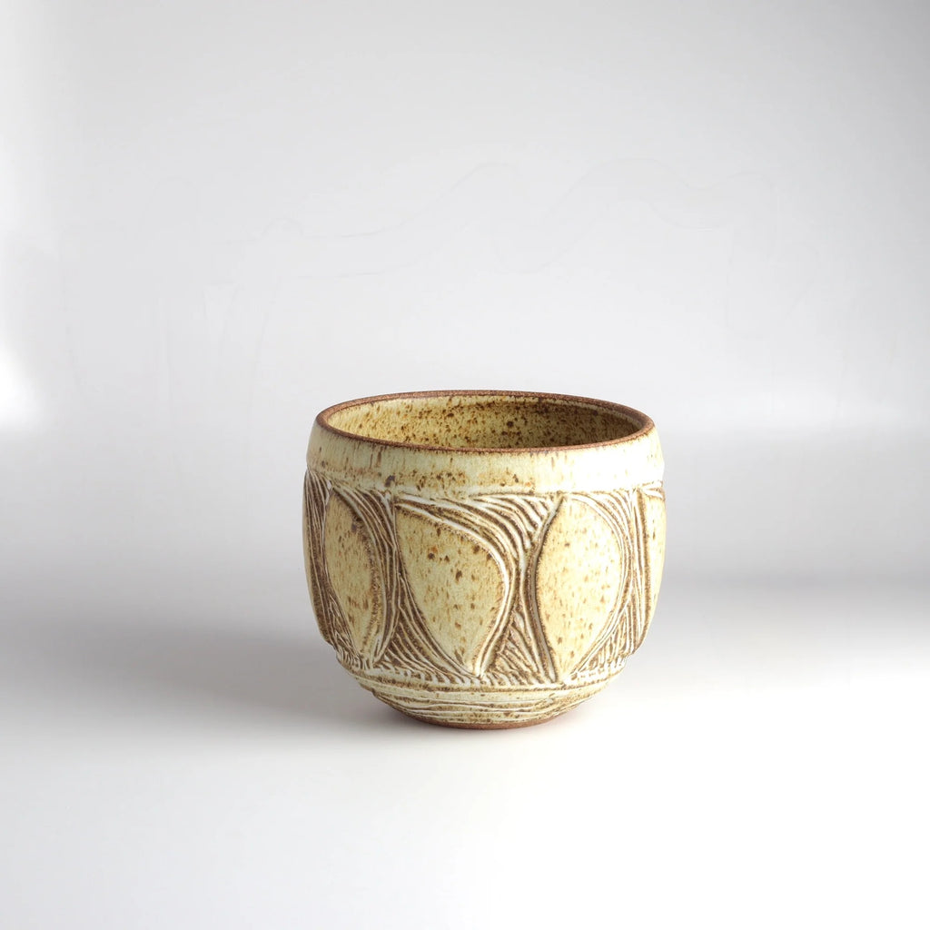 Aone of a kind hand carved Irving Place Studio (IPS) Ceramic Vases in cream made by Dora De Larios (1933-2018) on white background. 