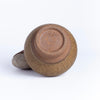 Showing stamp on beige bottle shaped vase by Irving Place Studio (IPS).
