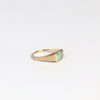 SIde view of Emerald Signet ring by Elizabeth Street Jewelry, a one of a kind lightly faceted Colombian emerald on a tapered band with squared edges in 14k satin finish yellow gold.