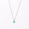 The duo bale emerald pendant in platinum by Elizabeth Street with platinum chain on white background.