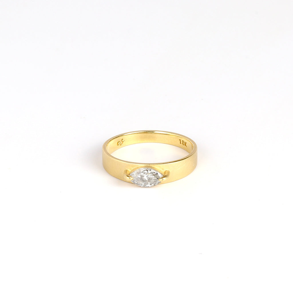 lim Cigar Band with Diamond by Elizabeth Street Jewelry on white background.This is a band with slight taper and a marquise cut salt and pepper diamond in a two prong eagle claw bezel setting, using 14k gold. Handmade in Los Angeles. Size 6.5 in stock.