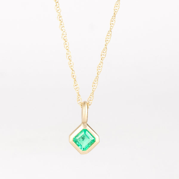 Off-Set Emerald Pendant Necklace by Elizabeth Street Jewelry is a bezel set and off-set square Colombian emerald .42ct on a 14k 18 inch long yellow gold chain. Perfect for layering or to wear as a solo piece. Handmade in Los Angeles.