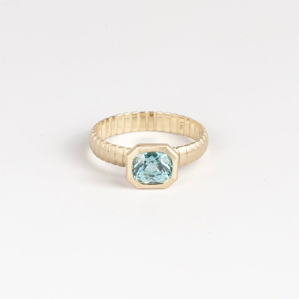 Blue Zircon Open Basket Signet on Ridged Band by Elizabeth Street Jewelry in size 6.5 is a one of a kind and oval cut blue zircon on a ridged band in 14k gold. Handmade in Los Angeles.