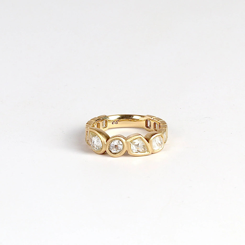Diamond Medley Band by Elizabeth Street on white background. A Mixed cut and bezel set radiant cut diamonds 2.18TCW with white baguette accented shank on a 14k yellow gold band with satin finish. Handmade in Los Angeles.