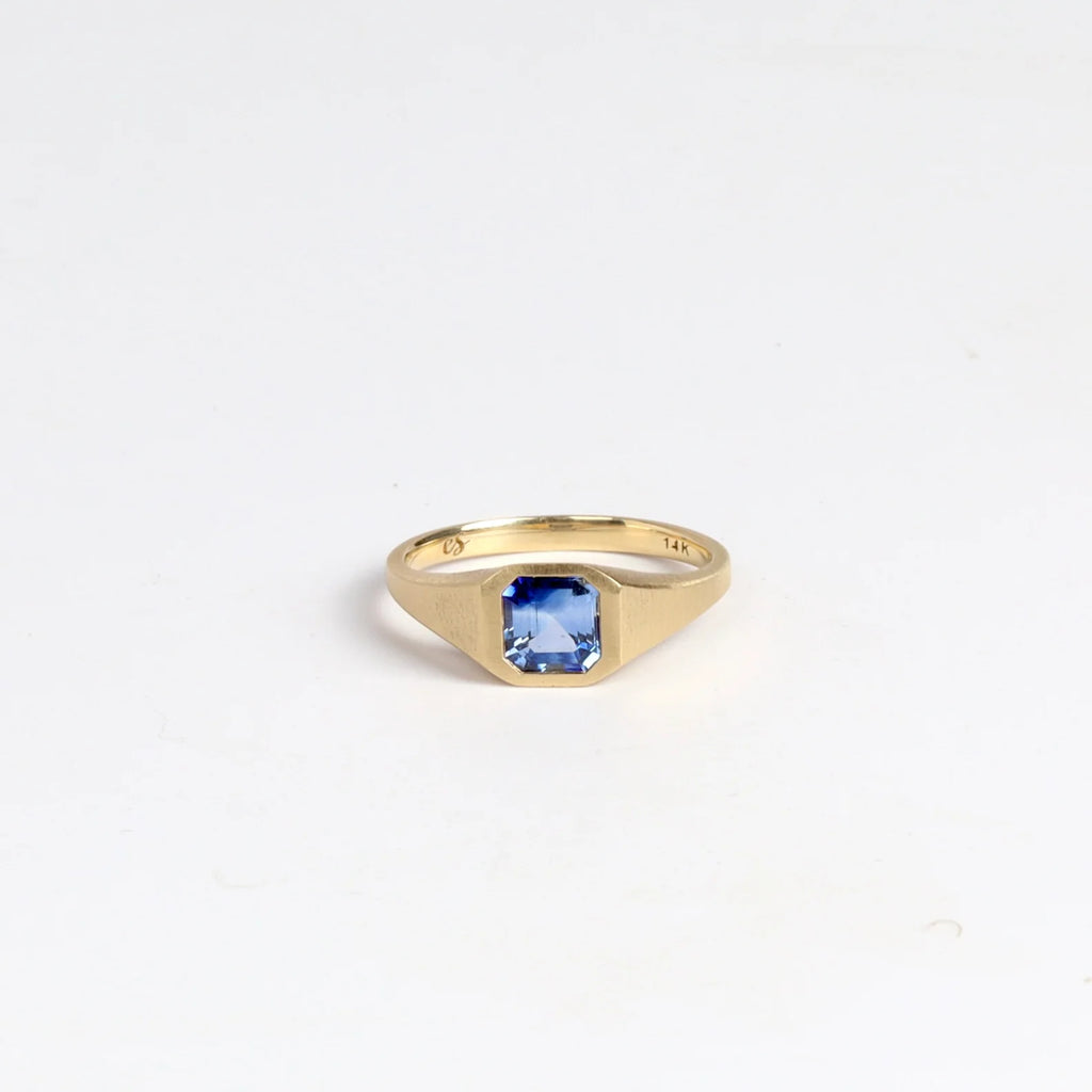 Ceylon Sapphire Signet by Elizabeth Street Jewelry is a one of a kind and near square petite signet comprised of a ceylon sapphire on a tapered band in 14k satin finish. Handmade in Los Angeles.