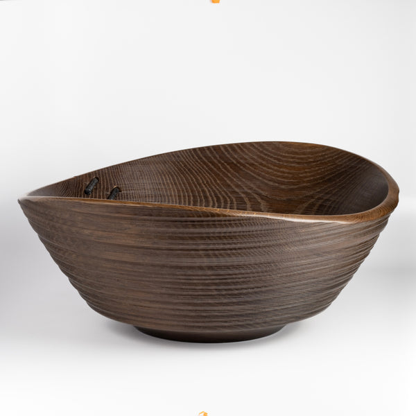 A big turned wood Circle Factory Bowl in Brown Oak With Ridges and Repair Detail by George Petersen on white background.
