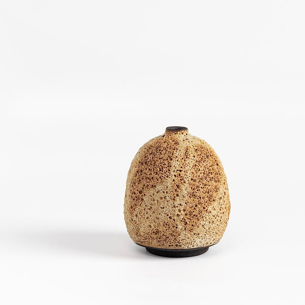 Striped cream to brown bottle  ceramic vase by Heather Rosenman on white background.