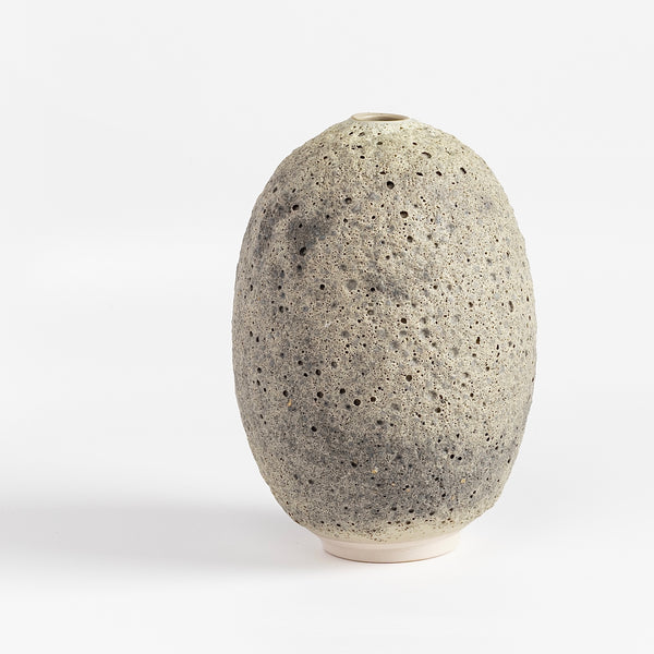 Heather Rosenman oval ceramic vase in gray to white volcanic glaze on white background.