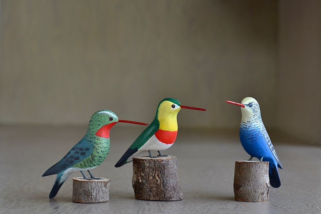 Birds from Brazil are hand carved and painted by a Brazilian maker. This is a selection of Humming birds.