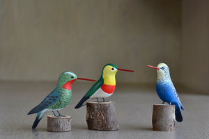 Birds from Brazil are hand carved and painted by a Brazilian maker. This is a selection of Humming birds.