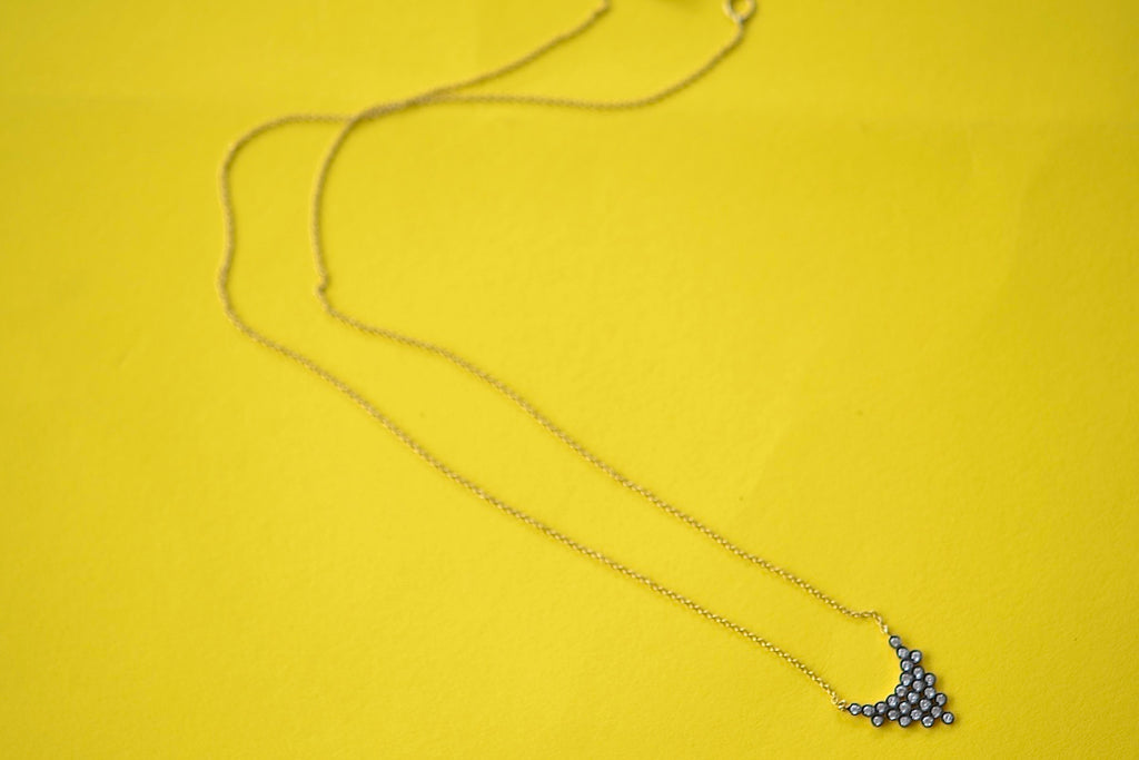 Charnières Pétale Pendant Necklace by Yannis Sergakis is twenty-Five (25) rhodium plated round cut diamonds that form a triangular pendant on an 18k gold chain.