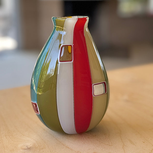 Lifestyle shot of Robin Mix Medium Flat Cane Murrini Vase with Windows 7" is a flat cane vase with Murrini and windows by Robin Mix. 
