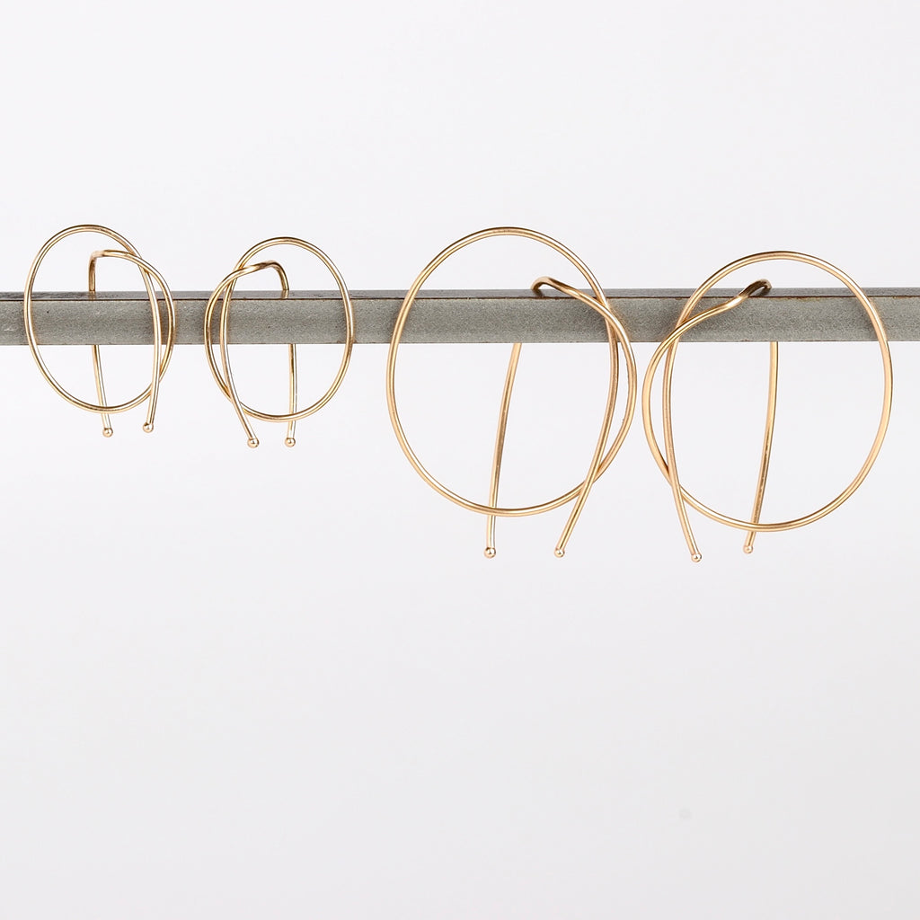 Kathleen Whitaker Rope earrings in small and medium. Gold wire is bent in a take on a classic hoop.