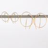 Kathleen Whitaker Rope earrings in small and medium. Gold wire is bent in a take on a classic hoop.