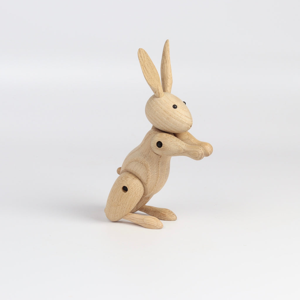 Side view of Kay Bojesen Wood Rabbit on white background.