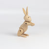 Side view of Kay Bojesen Wood Rabbit on white background.