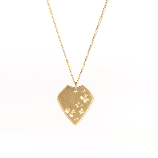 Petal Print Pick Necklace by Kaylin Hertel is a guitar pick shaped pendant on white background.