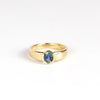 Tapered Band Blue Sapphire Solitaire designed by Kaylin Hertel on white background. Sapphire engagement ring.