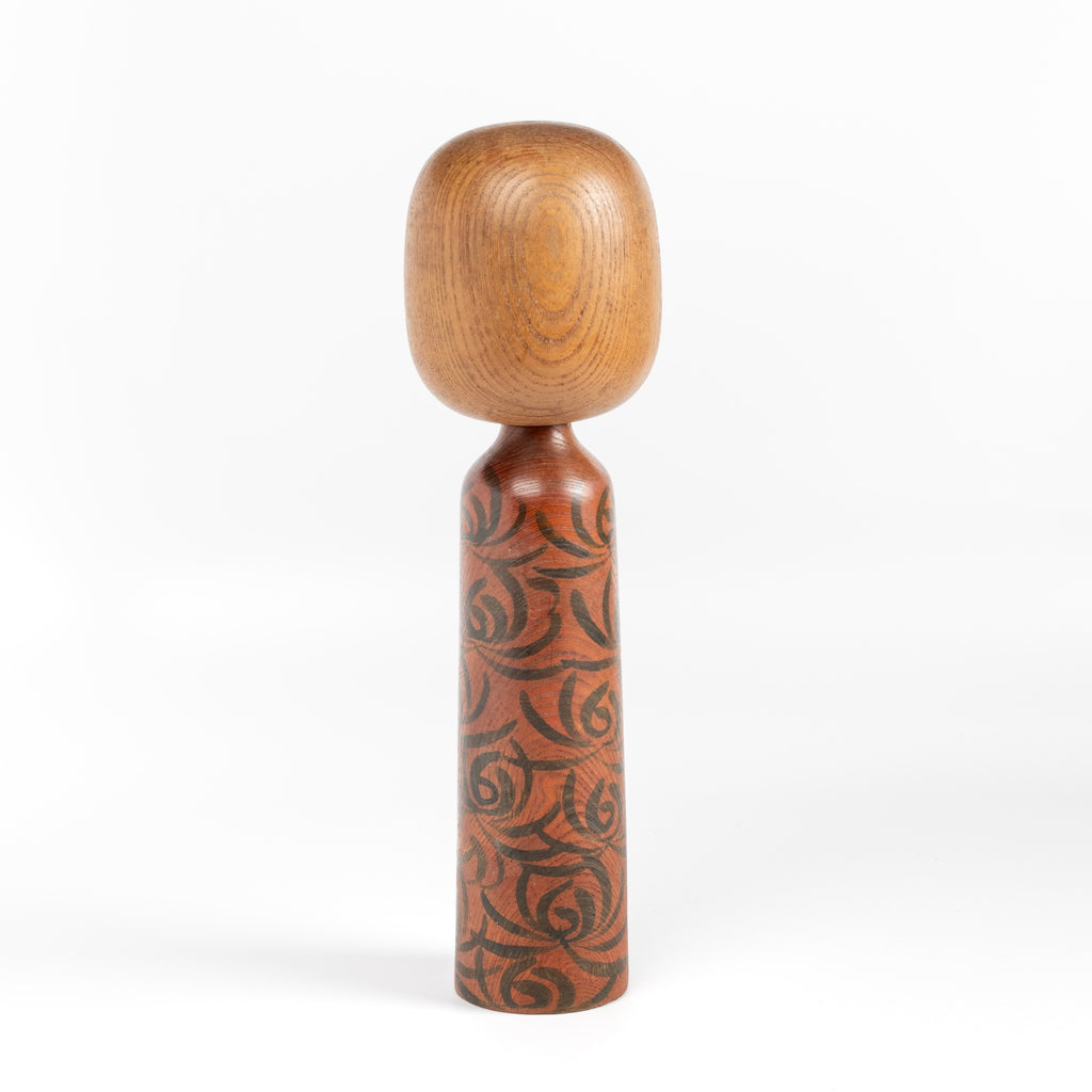 Back of dark forest green kokeshi doll.