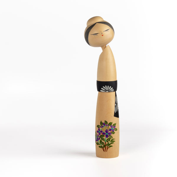 Beautiful Sosaku Kokeshi by master Sato Suigai (1920-).This one has purple flowers.