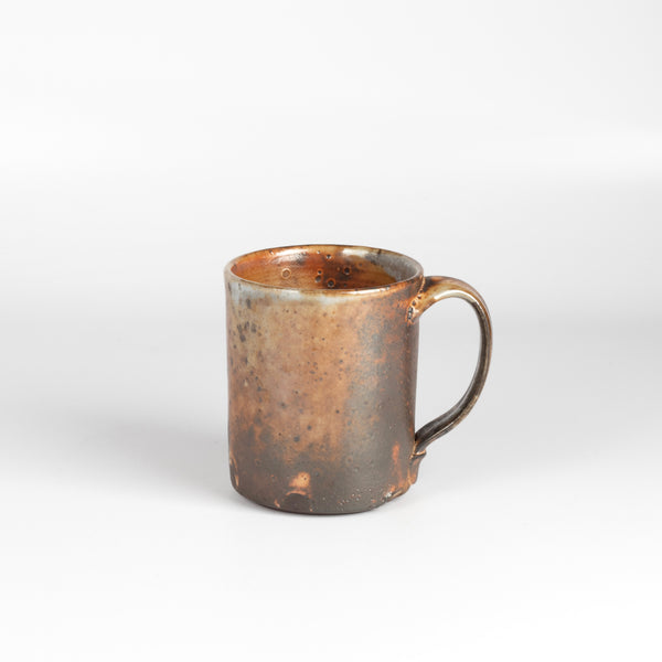 The LO mug is a wood fired ceramic mug by Lindsey Oesterritter. Wood ash in the kiln results in highly varying surfaces so each one unique and one of a kind. This one is number 1.