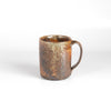 The LO mug is a wood fired ceramic mug by Lindsey Oesterritter. Wood ash in the kiln results in highly varying surfaces so each one unique and one of a kind. This one is number 2.