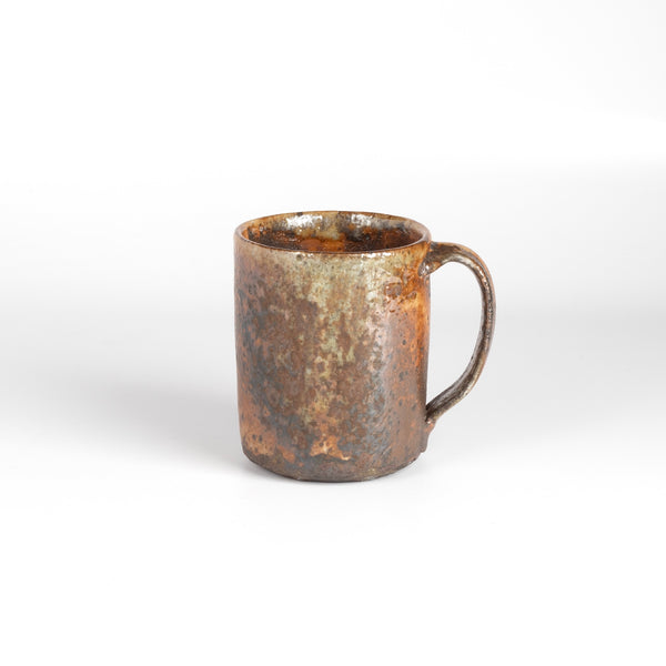 The LO mug is a wood fired ceramic mug by Lindsey Oesterritter. Wood ash in the kiln results in highly varying surfaces so each one unique and one of a kind. This one is number 2.