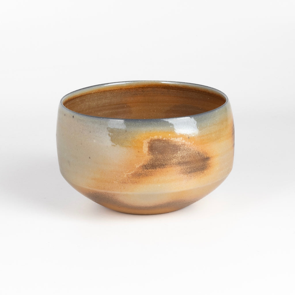 Wood Fired Tea Bowl #2 is a one of a kind wood fired and reduction cooled  matcha tea bowl in peach, brown, blue and gray. It's hand thrown and porcelain by Lilith Rockett. 