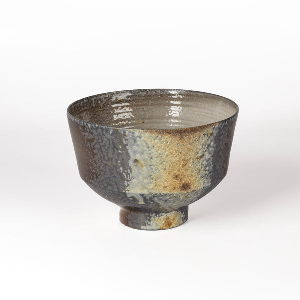 azegama Wood Fired Footed Tea Bowl is an exquisite one of a kind wood fired and reduction cooled tea bowl in grays and browns with a textured stripe. Hand thrown porcelain by Lilith Rockett, who works out of Portland, Oregon.