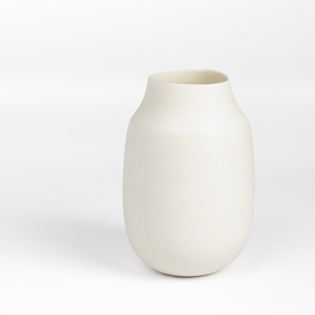 Lilith Rockett Vase with Neck "A" is Reminiscent of an eggshell, this vase is wheel thrown porcelain with gloss glaze on the interior and an unglazed exterior. It has been sanded smooth and it is very stable despite its rounded bottom. 