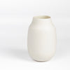 Lilith Rockett Vase with Neck "A" is Reminiscent of an eggshell, this vase is wheel thrown porcelain with gloss glaze on the interior and an unglazed exterior. It has been sanded smooth and it is very stable despite its rounded bottom. 