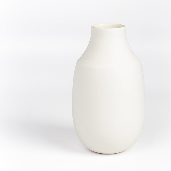 Lilith Rockett Vase with Neck "B" is Reminiscent of an eggshell, this vase is wheel thrown porcelain with gloss glaze on the interior and an unglazed exterior. It has been sanded smooth and it is very stable despite its rounded bottom. 