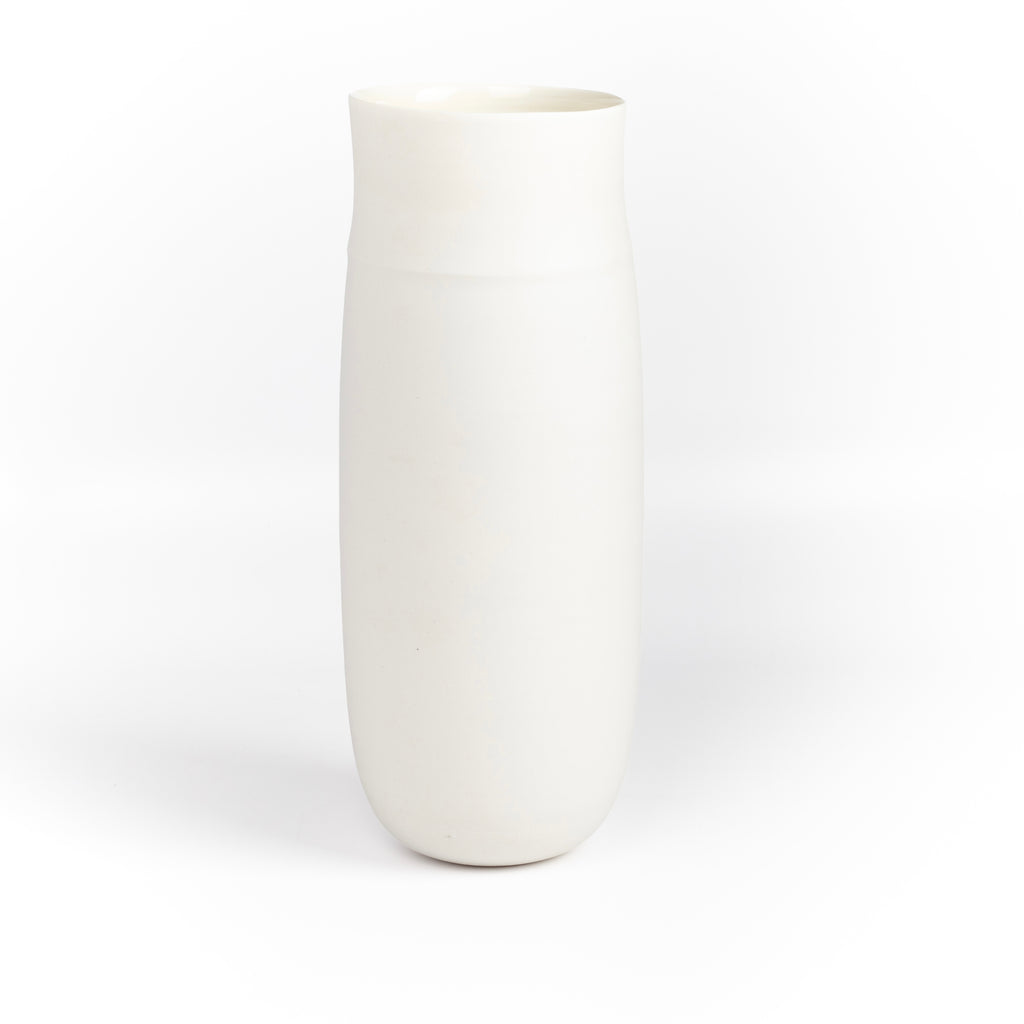 Lilith Rockett Tall vase is reminiscent of an eggshell. It is hand thrown porcelain with gloss glaze on the interior and an unglazed exterior that has been sanded smooth and it is very stable despite its rounded bottom. Handmade in Portland, Oregon. 