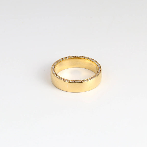 Slim Pave Othello Cigar Band on white background. This  is a slim pavé 18k polished slightly rounded band by Lizzie Mandler with black diamonds on one side and white diamonds on the other. Handmade in Los Angeles