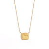 Lion and the Mouse Duo Motto Necklace by Makita Wakita in 18k yellow gold on white background. 