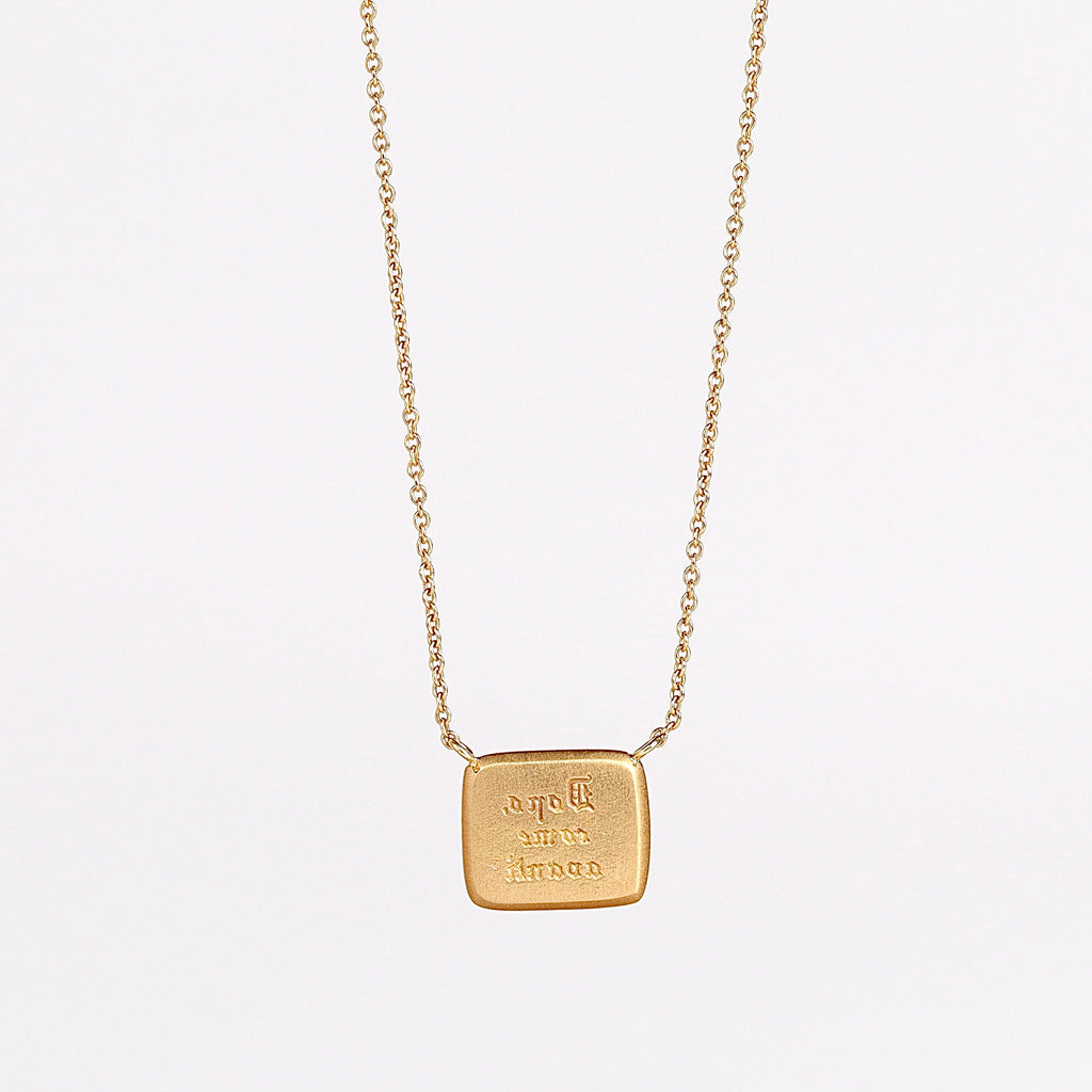 Reverse side of Lion and the Mouse Duo Motto Necklace by Makita Wakita in 18k yellow gold on white background. 