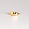 Side view of Rectangle Reflection Signet by Makiko Wakita, an 18k high polish signet ring with crisp edges and a horizontally oriented slightly rectangularl face. This signet ring is unisex. Size 6. Handmade in Los Angeles.