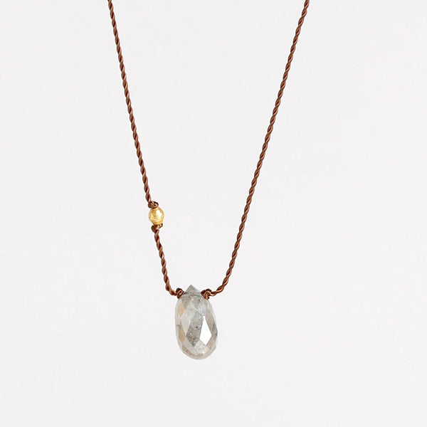 A raw and faceted gray diamond is accented with an 18k gold bead on poly nylon string to form this one of a kind organic necklace. Designed by Margaret Solow. 