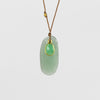 Close up of Chrysoprase and Sapphire necklace, a one of a kind lightly faceted Chrysoprase stone slice accompanied by a smaller green and faceted sapphire slice of which the smaller is set in 18k gold with with a gold bead on the string makes this one of a kind &nbsp;organic pendant necklace. Designed by Margaret Solow. Handcrafted in Los Angeles.