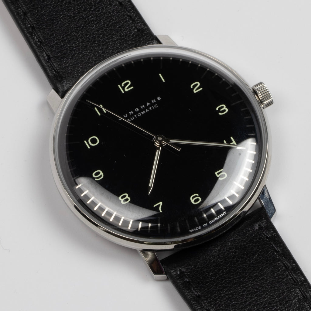 Max Bill 38mm Automatic Watch in Black Dial with Numbers but no date is a modernist classic designed wrist watch by designer Max Bill for Junghans. It is a classic modernist design with automatic movement J800.1 automatic (ETA 2824-2 base) and a sapphire crystal,  42 Hour Power Reserve in 316L stainless steel case available at OK