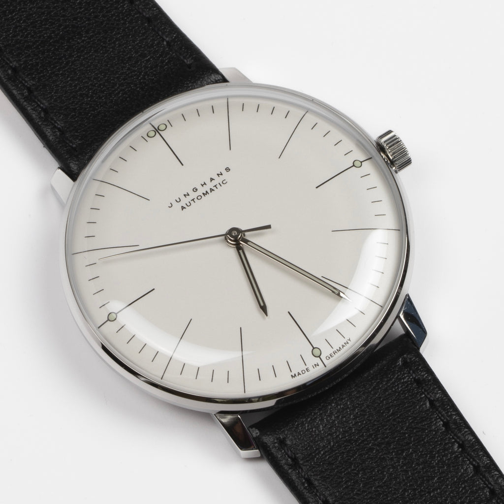 Max Bill 38mm Automatic Watch White Dial with Lines but no date 27/3501.02 is a modernist classic designed wrist watch by designer Max Bill for Junghans. It is a classic modernist design with automatic movement J800.1 and a sapphire crystal and stainless steel case available at OK.