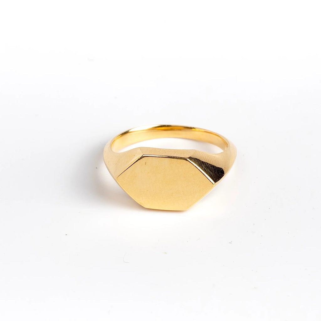 Hexagonal Reflection Signet ring by Makiko Wakita is an 18k high polish signet ring with crisp edges and a hexagonal face. The band has s beautiful knife edge. This signet ring is unisex. A Handmade in Los Angeles. 